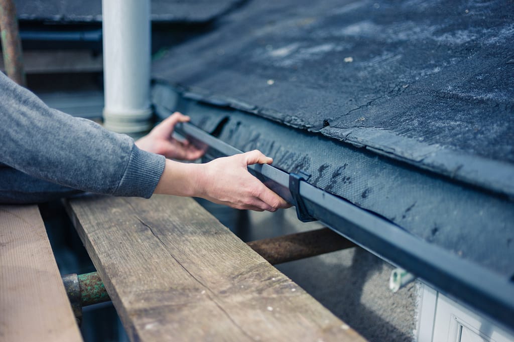 Hands adjusting gutters - Roofing Companies in Harford County - Home Crafters Roofing & Contractors