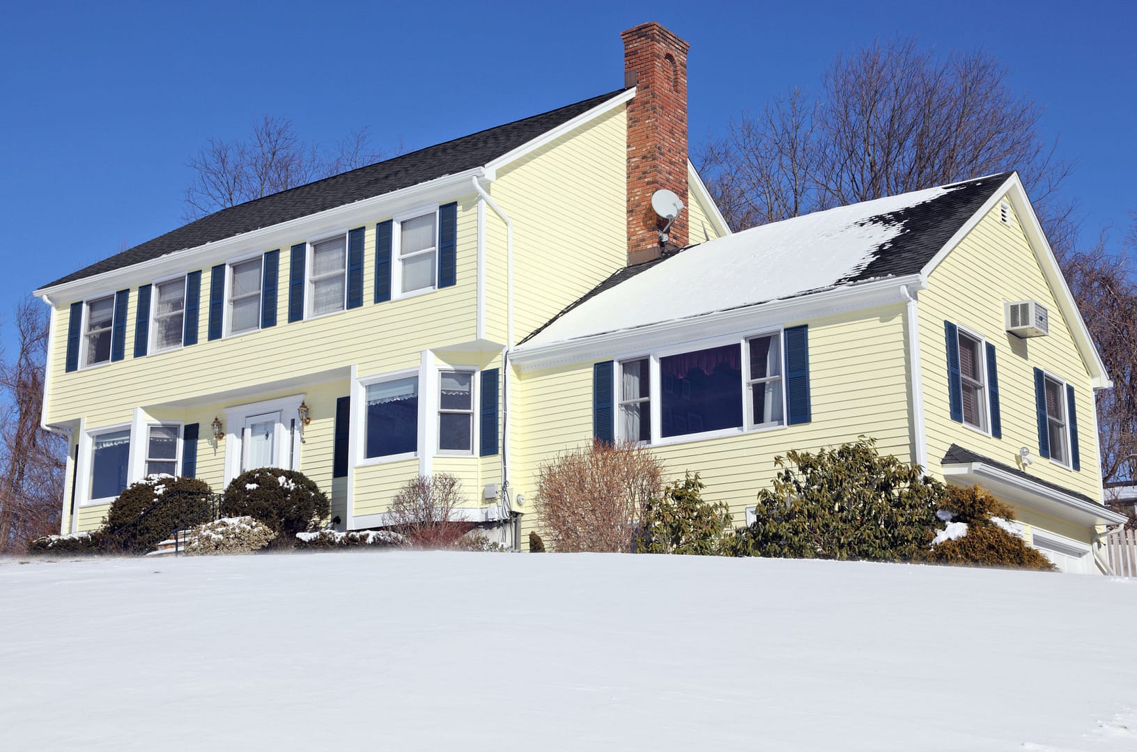 American house with snowy roof - roofing companies in Baltimore county - Home Crafters