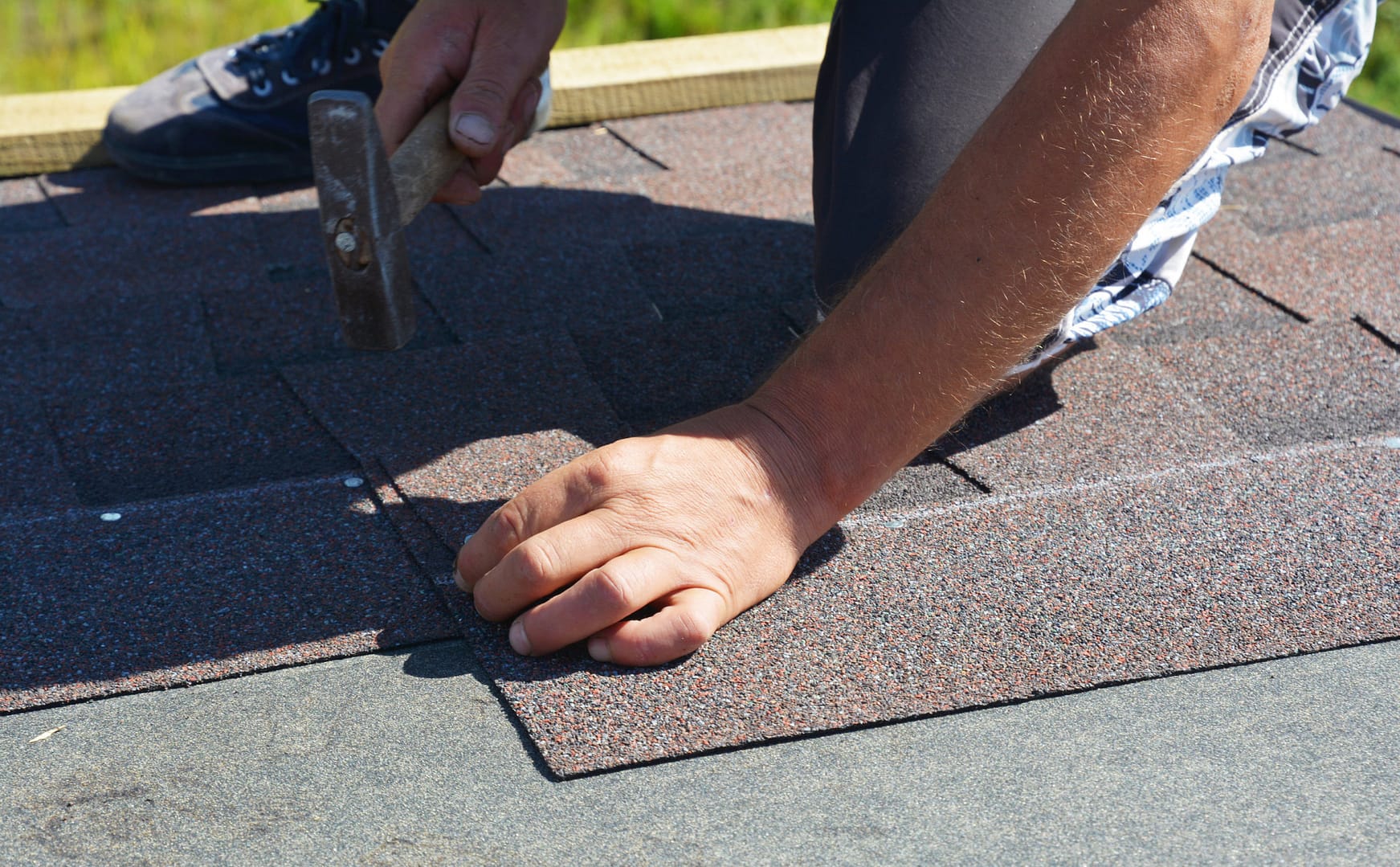 A man repairs shingles - Roofing Companies in Carroll County - Home Crafters Roofing & Contracting